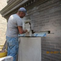 Placing key stone over new lintel